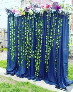 DRAPED BACKDROP WITH ARTIFICAL FLORAL VALANCE