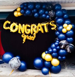 CIRCLE BACKDROP WITH BALLOON GARLAND AND BALLOON LETTER SIGN