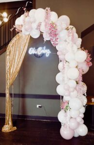 GOLD ARCH WITH FLORAL BALLOON GARLAND AND LED SIGN